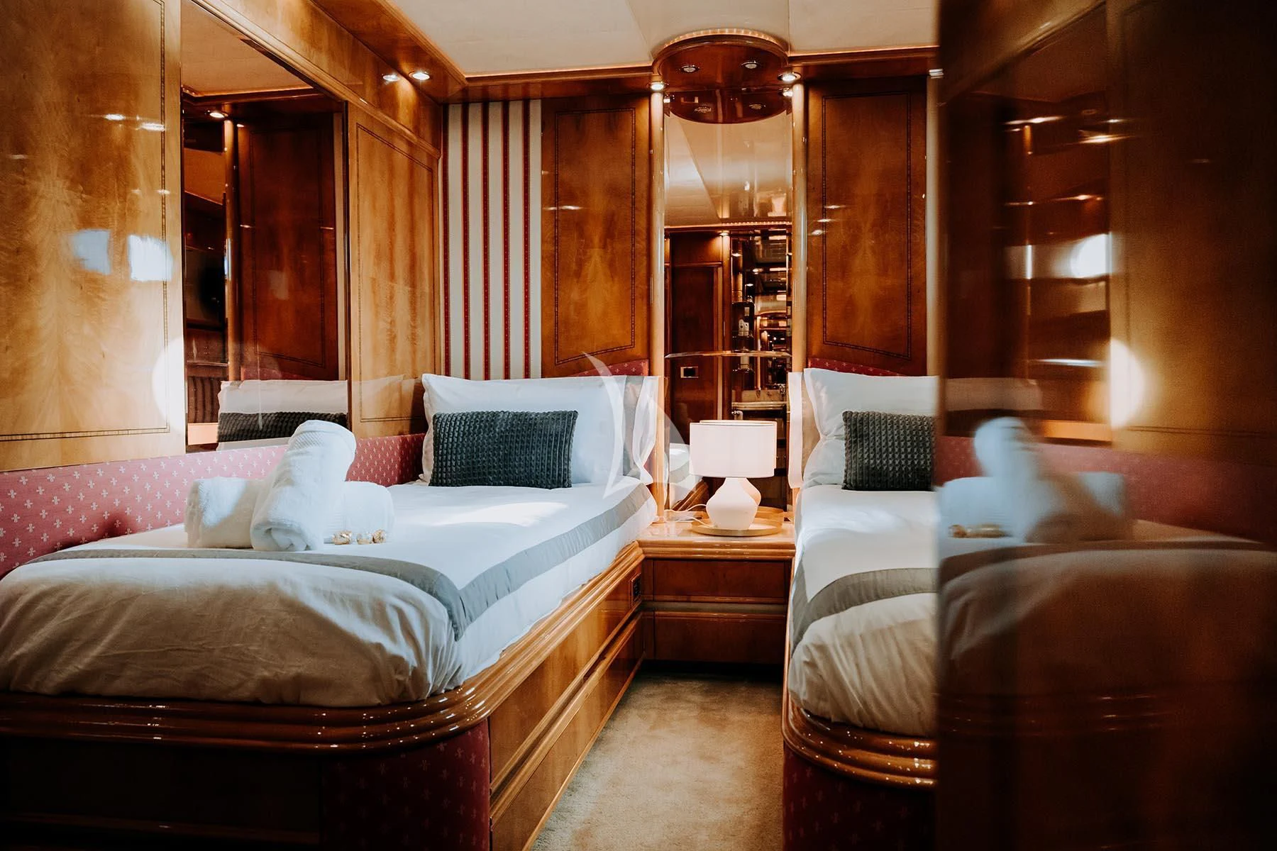 a room with a bed and a mirror aboard SONRISA SEPTIMO Yacht for Sale