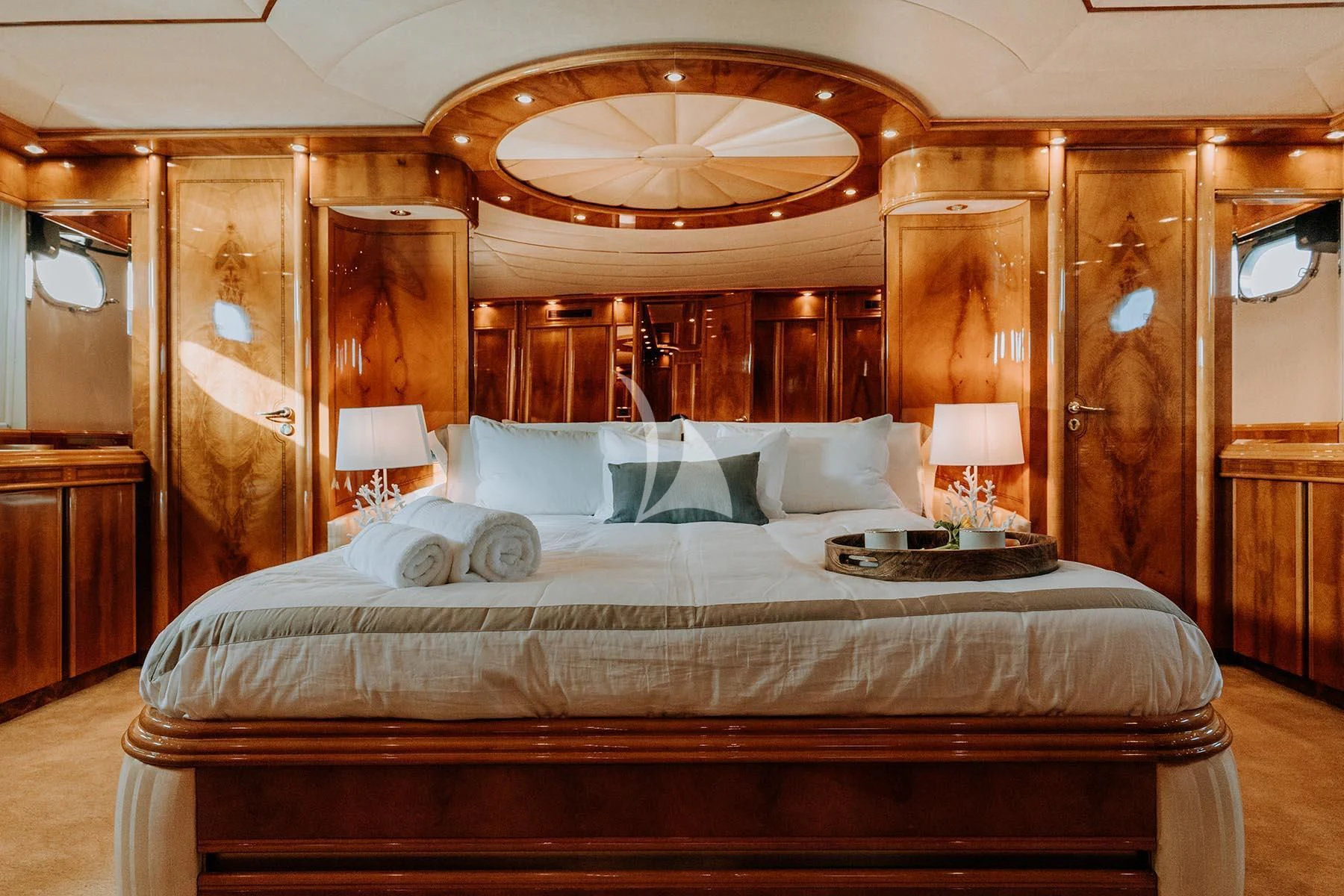 a bed with a large mirror above it aboard SONRISA SEPTIMO Yacht for Sale