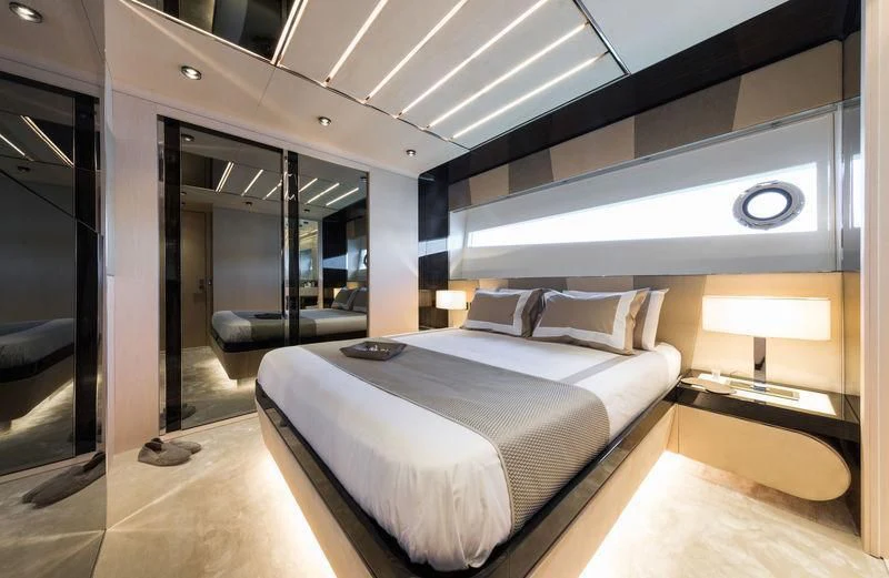 a room with a bed and a large mirror aboard MAXIMUS Yacht for Sale