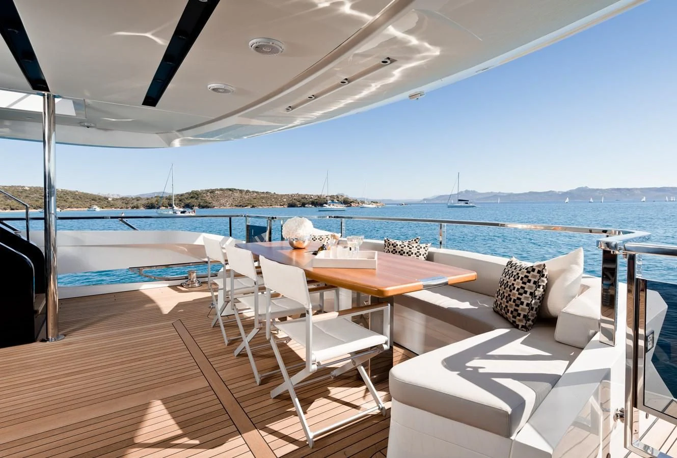 a deck with a table and chairs on it aboard MAXIMUS Yacht for Sale