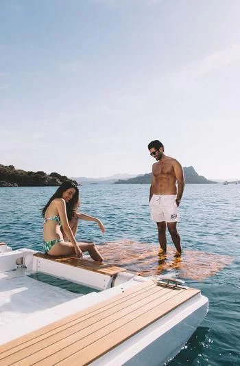 a man and woman standing on a boat in the water aboard MAXIMUS Yacht for Sale