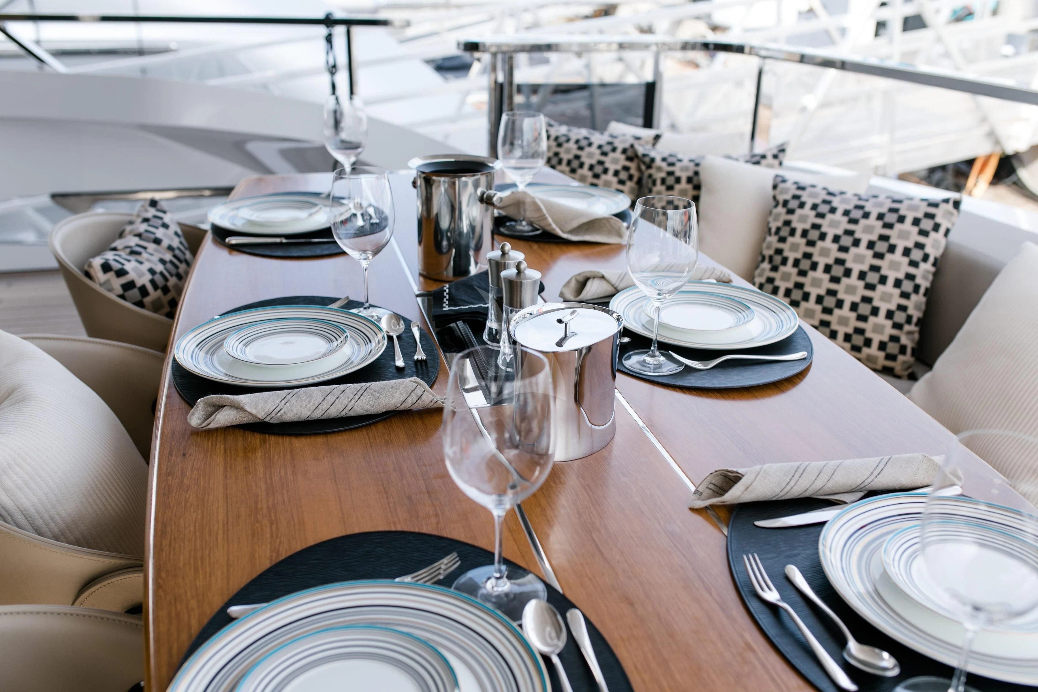 a table set with plates and silverware aboard MAXIMUS Yacht for Sale