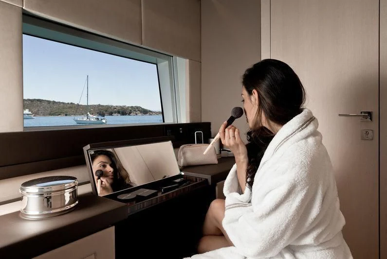 a person in a white coat talking on a cell phone aboard MAXIMUS Yacht for Sale