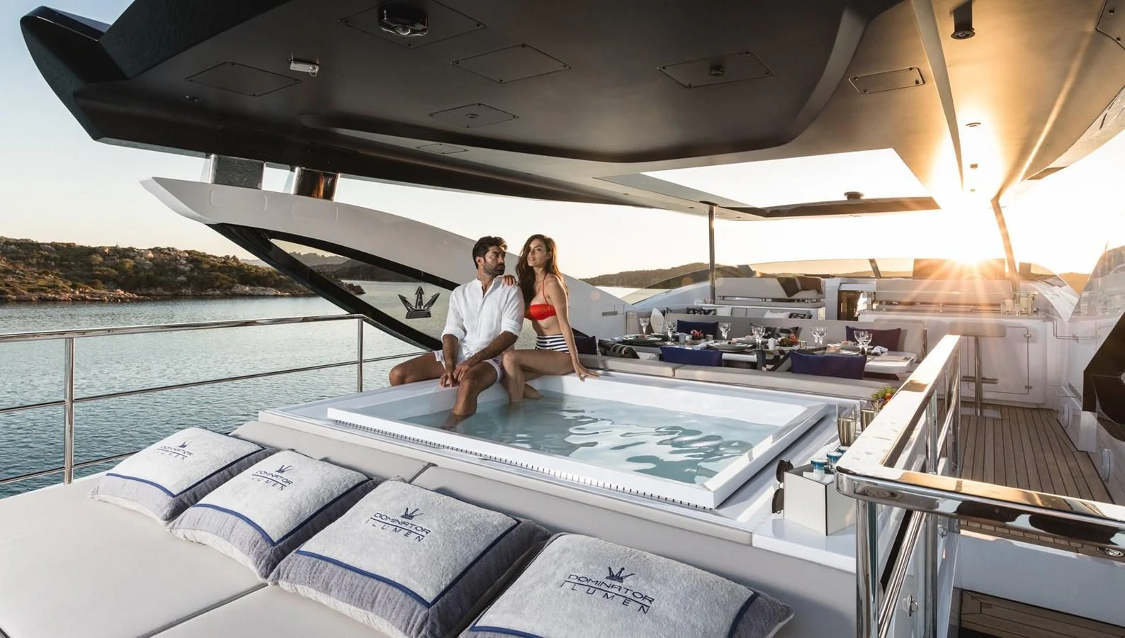 a man and woman sitting on a boat on the water aboard MAXIMUS Yacht for Sale