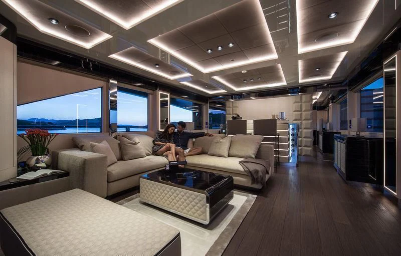 a couple of people sitting on a couch in a living room aboard MAXIMUS Yacht for Sale