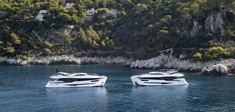 a couple of boats on the water aboard MAXIMUS Yacht for Sale