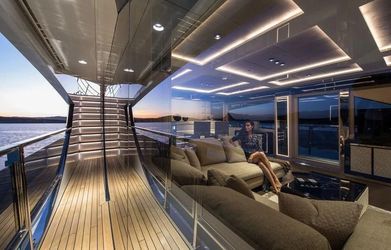 a person sitting on a couch in a room with a large window aboard MAXIMUS Yacht for Sale