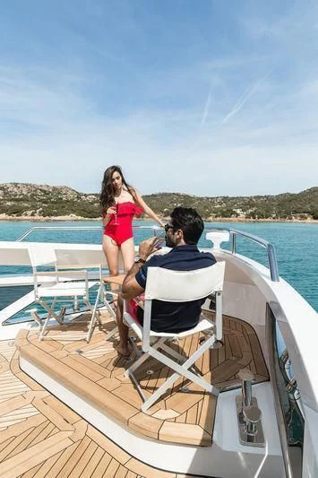 a man and woman kissing on a boat aboard MAXIMUS Yacht for Sale