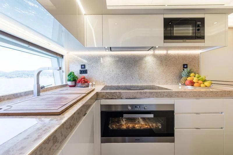 a kitchen with a stove and a window aboard MAXIMUS Yacht for Sale