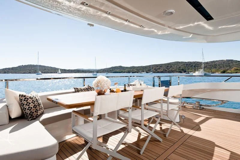 a lounge area on a deck overlooking a body of water aboard MAXIMUS Yacht for Sale