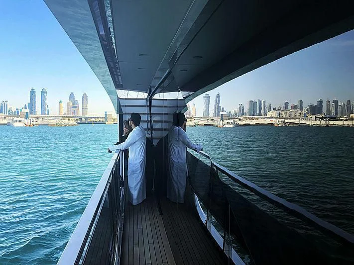 a group of men standing on a boat in the water aboard MAXIMUS Yacht for Sale