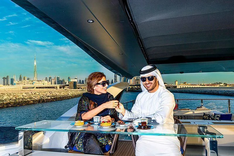 a couple sitting at a table on a boat aboard MAXIMUS Yacht for Sale