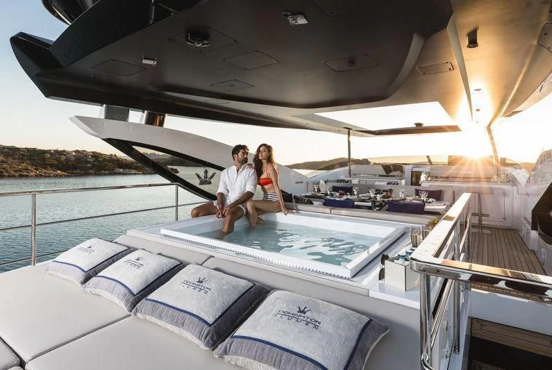a couple sitting on a boat aboard MAXIMUS Yacht for Sale