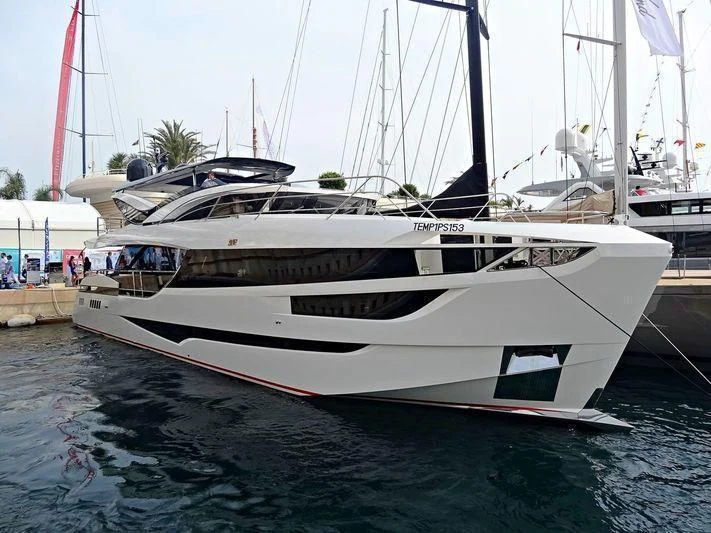 a white yacht in a harbor aboard MAXIMUS Yacht for Sale