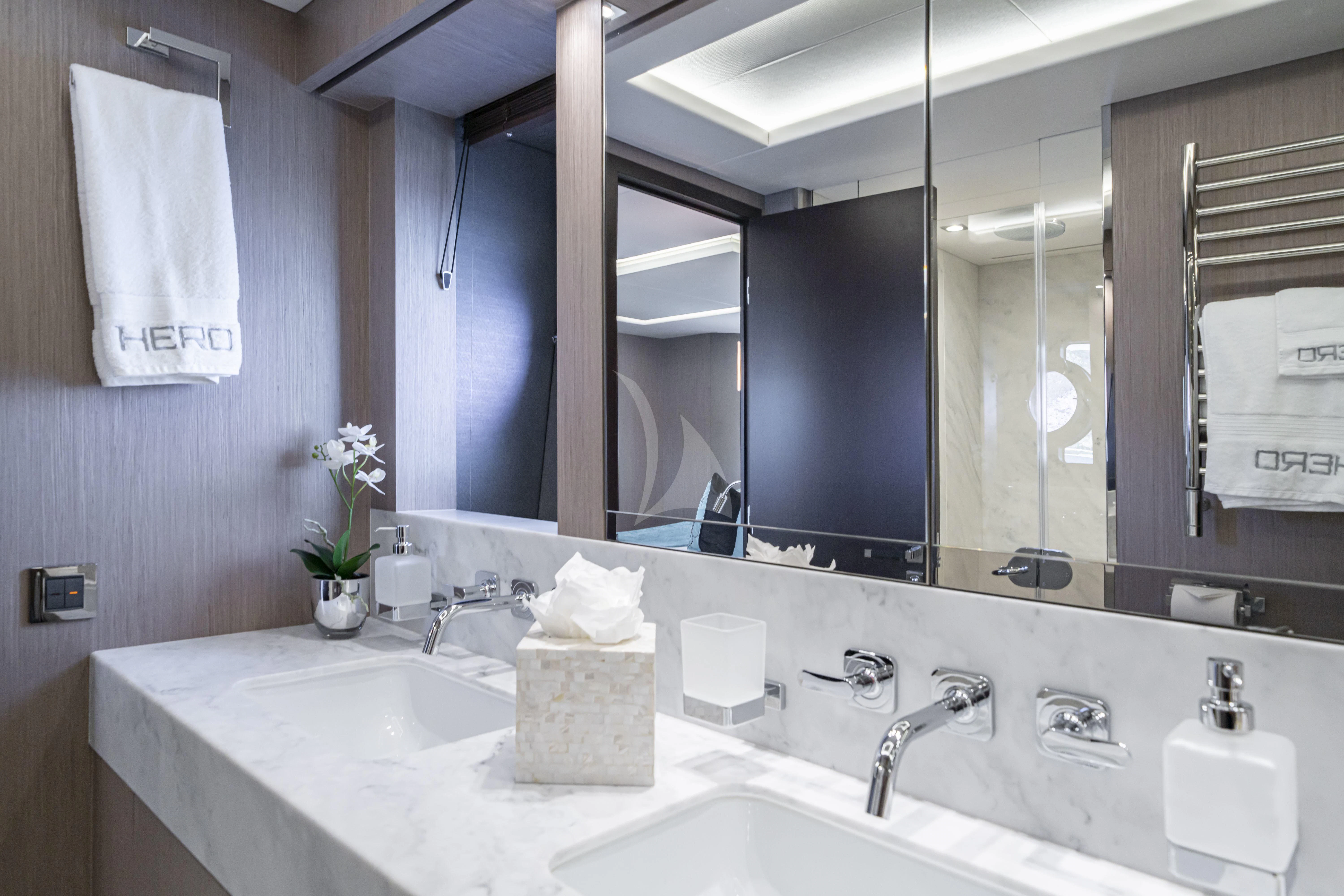 a bathroom with a large mirror aboard TORO Yacht for Sale