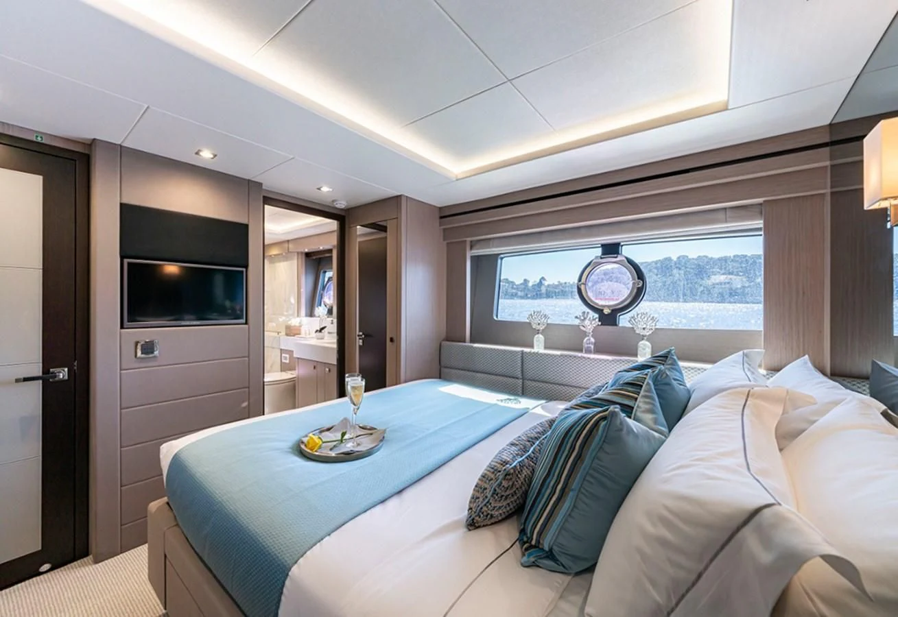 a bedroom with a blue table aboard TORO Yacht for Sale