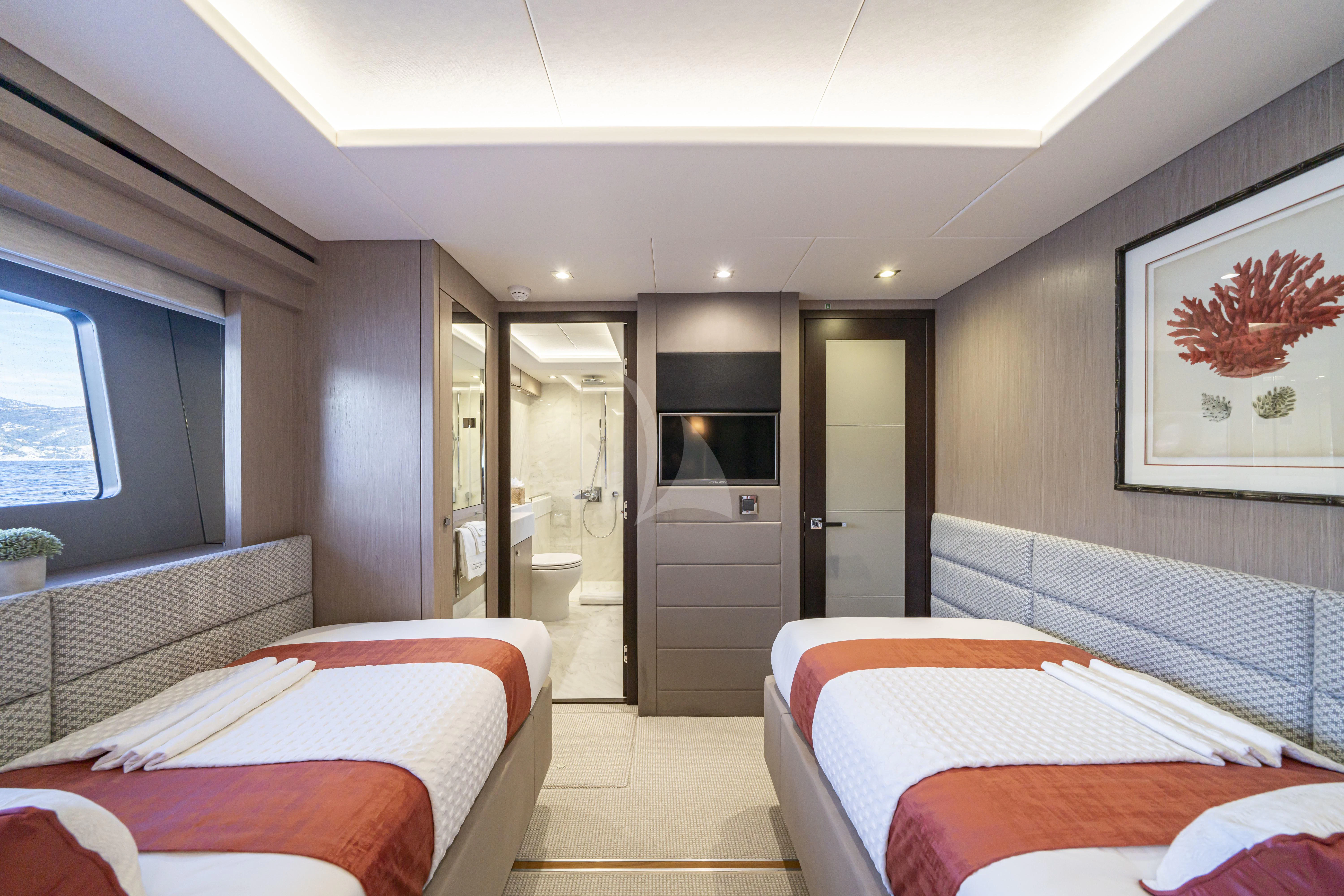 a bedroom with a bed and a tv aboard TORO Yacht for Sale