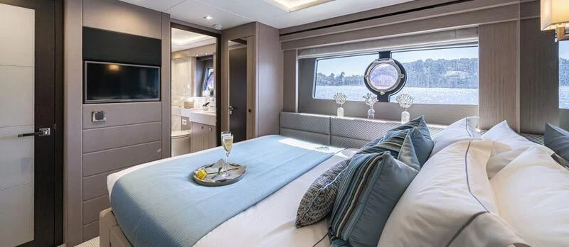 a bed with a blue blanket aboard TORO Yacht for Sale
