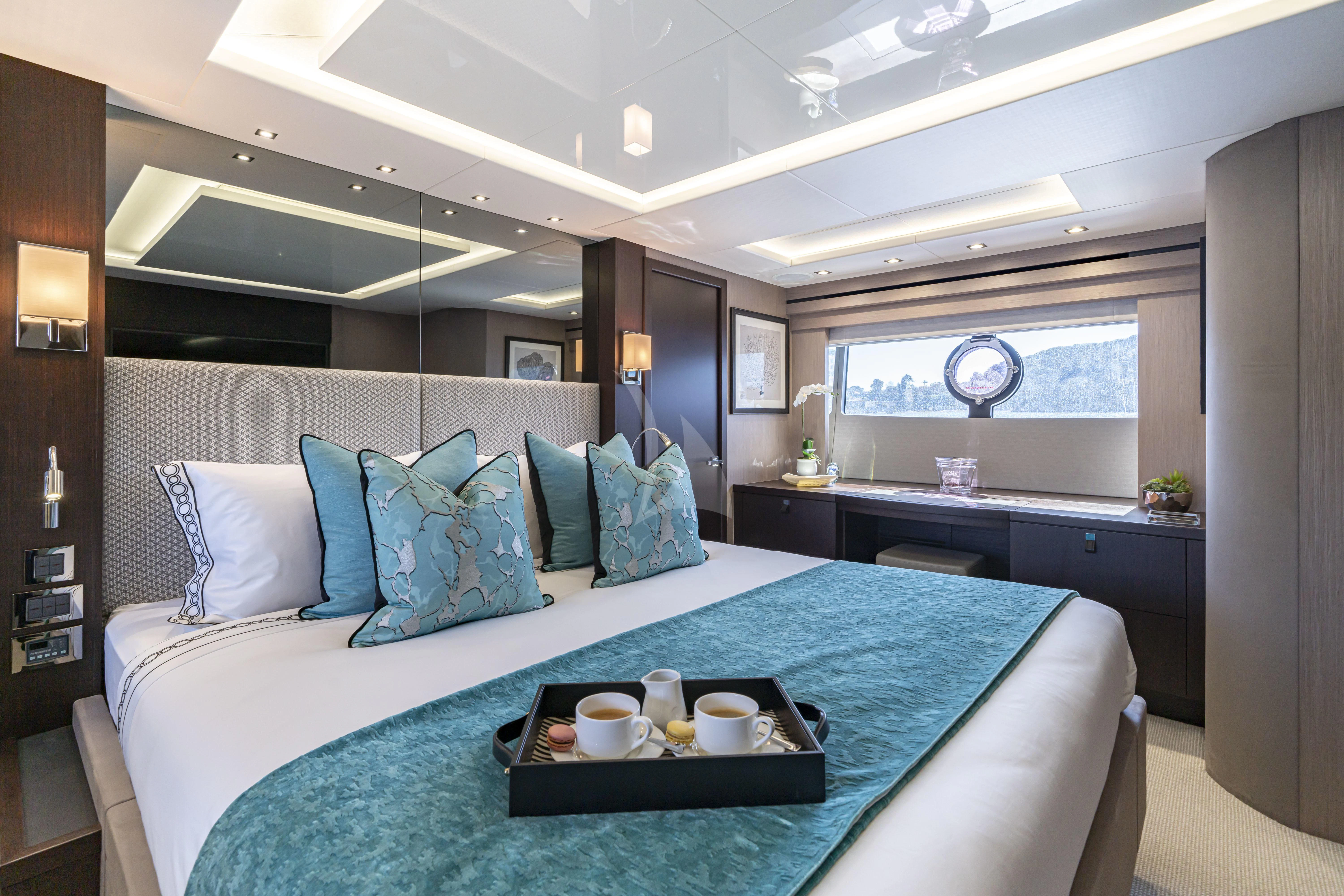 a bed with blue sheets aboard TORO Yacht for Sale