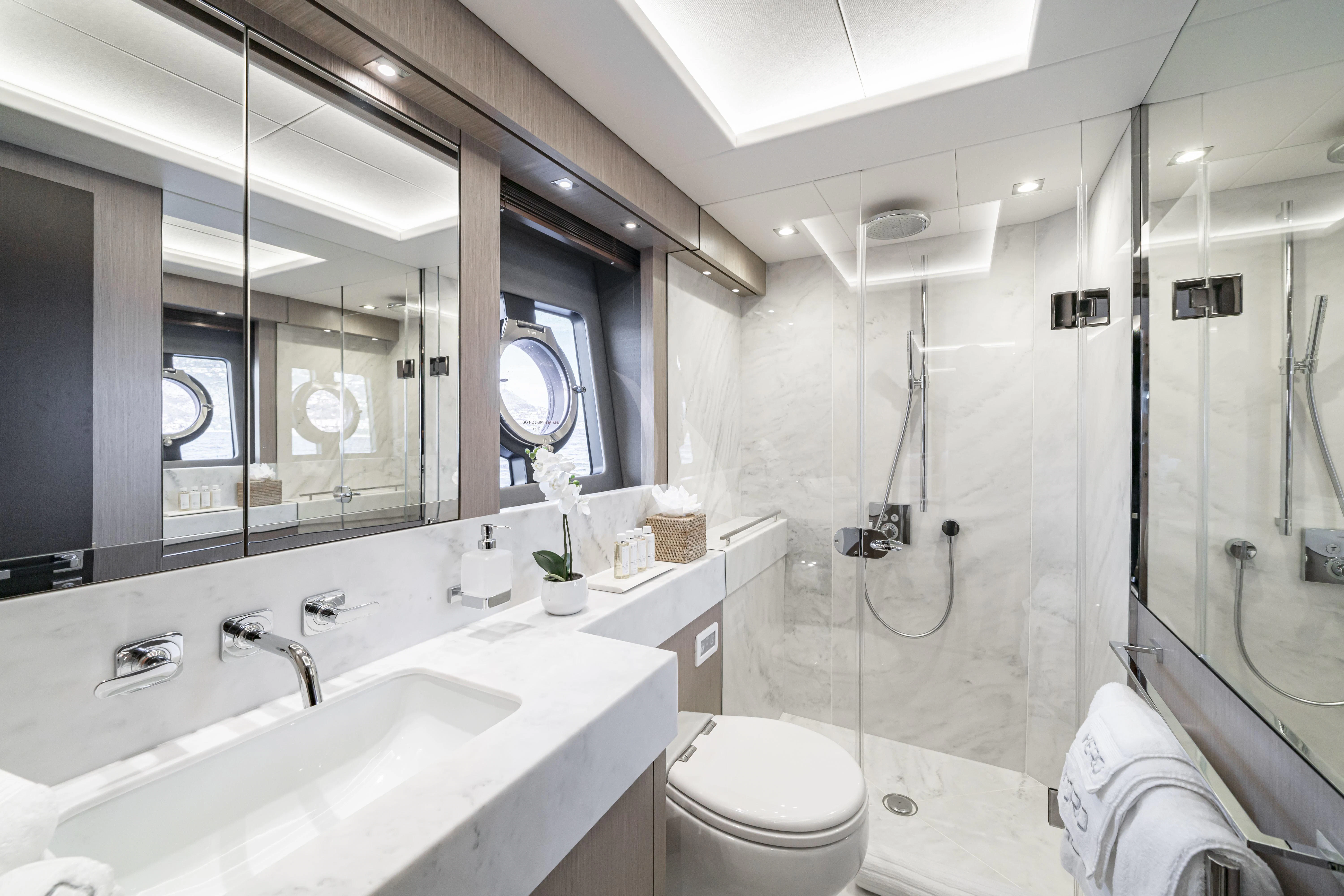 a bathroom with a glass shower aboard TORO Yacht for Sale