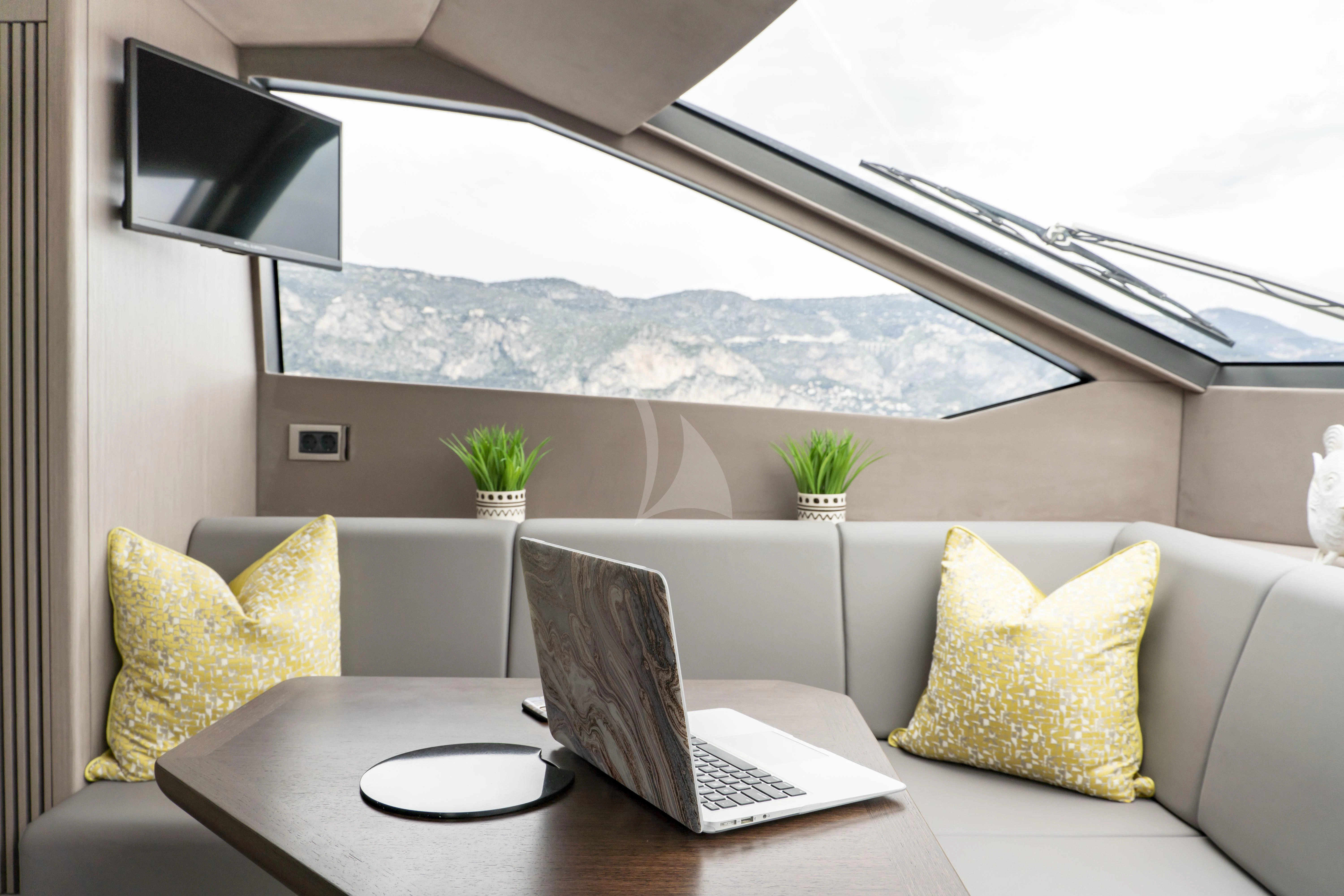 a laptop on a table aboard TORO Yacht for Sale