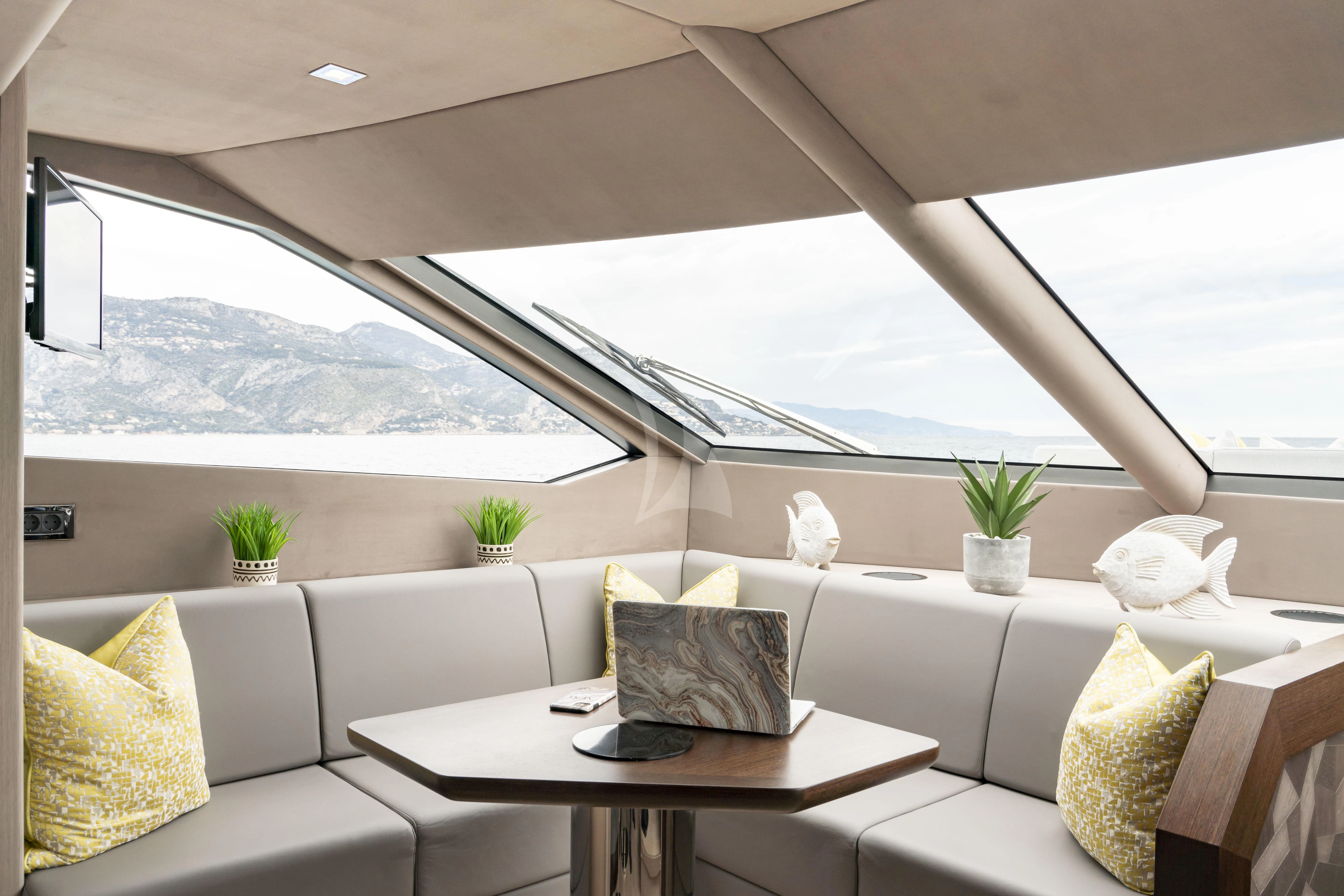 a room with a table and chairs aboard TORO Yacht for Sale