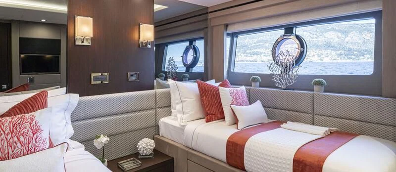 a room with a bed and a window aboard TORO Yacht for Sale
