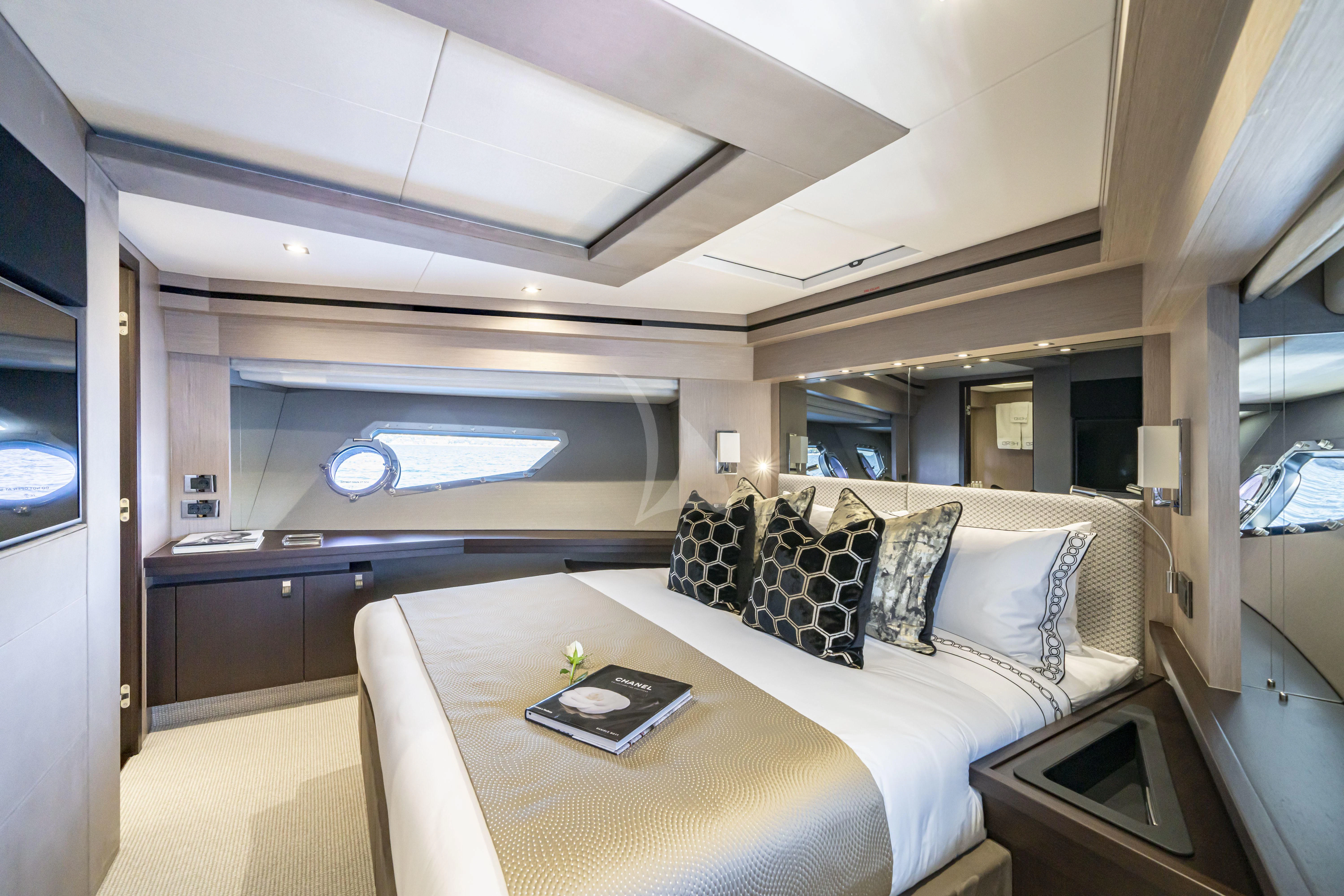 a bedroom with a bed and a desk aboard TORO Yacht for Sale