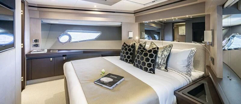 a room with a bed and a table aboard TORO Yacht for Sale