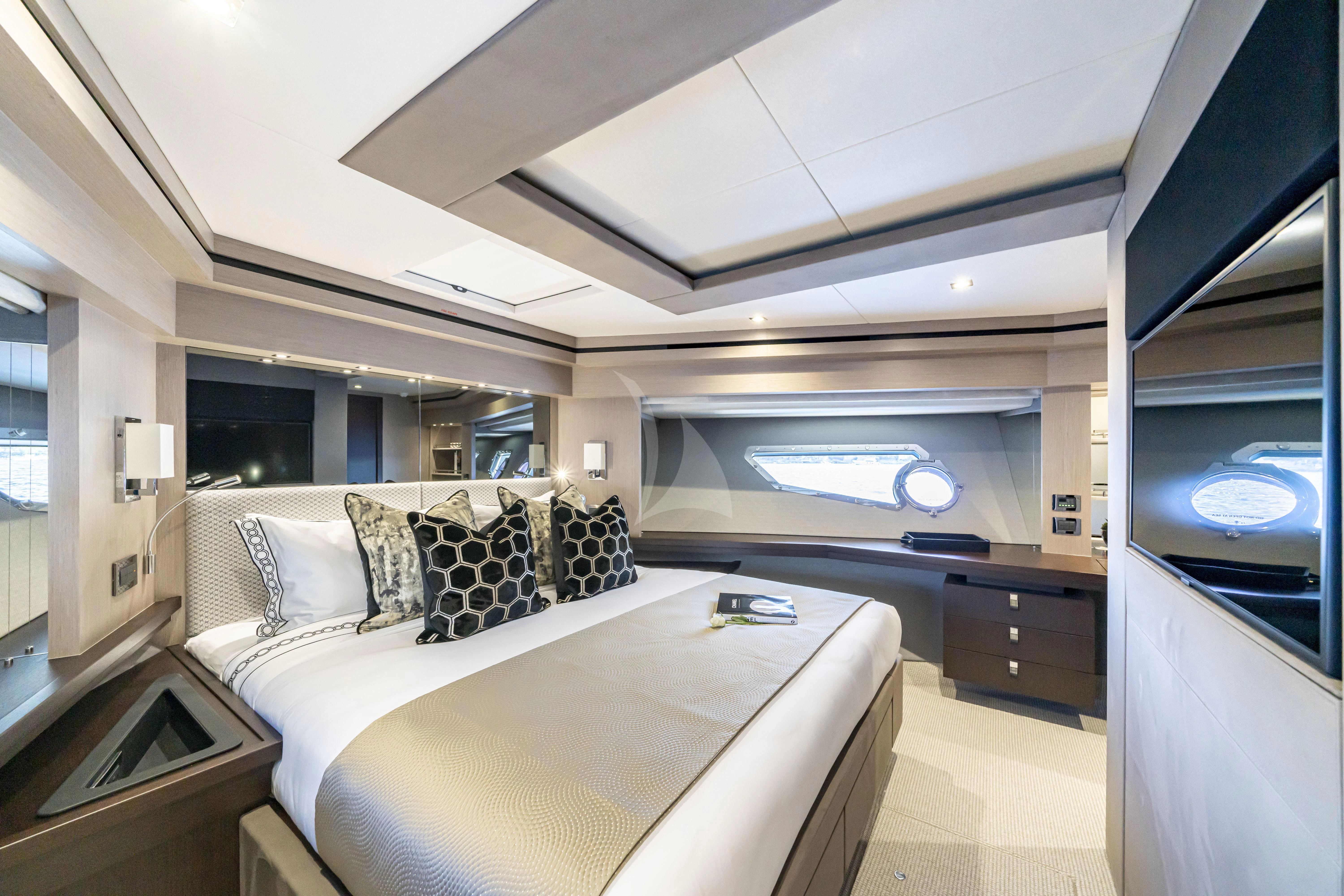 a bedroom with a bed and a tv aboard TORO Yacht for Sale