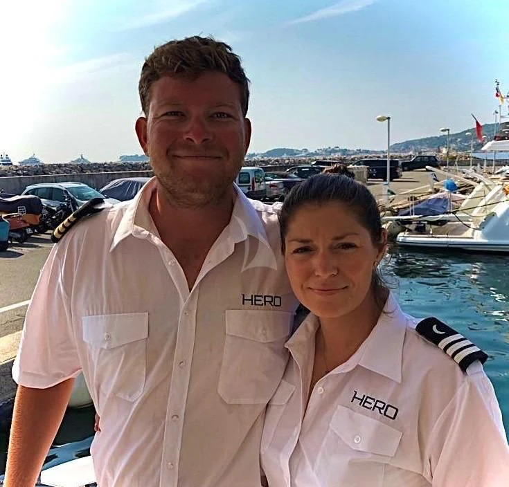a man and woman smiling for a picture aboard TORO Yacht for Sale