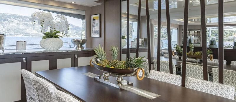 a room with a table and chairs aboard TORO Yacht for Sale