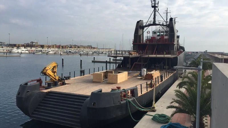 a large ship docked at a port aboard AFTHONIA V Yacht for Sale