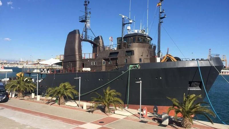 a large ship docked at a port aboard AFTHONIA V Yacht for Sale