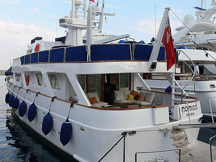 a boat with a red and blue stripe aboard NOMAD Yacht for Sale