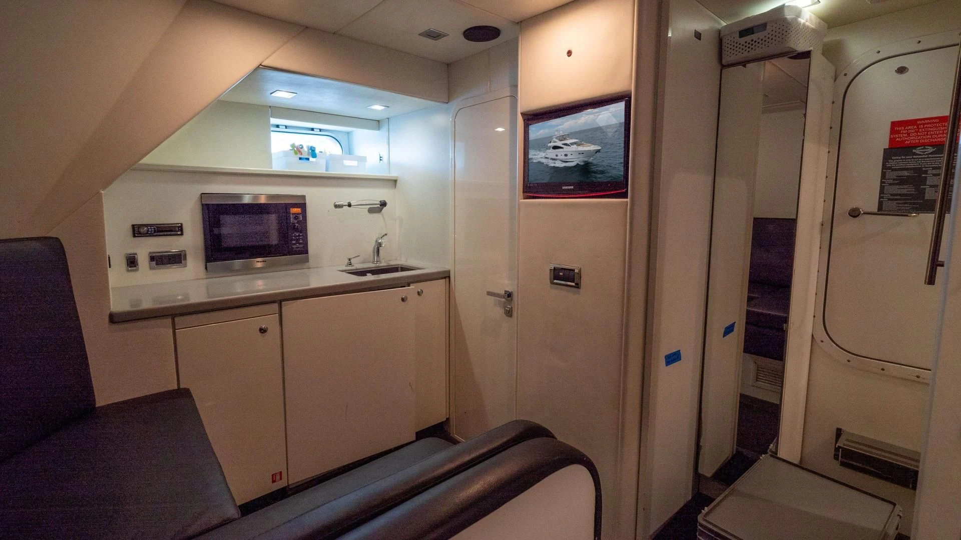a small kitchen with a couch aboard SPLASHED OUT Yacht for Sale