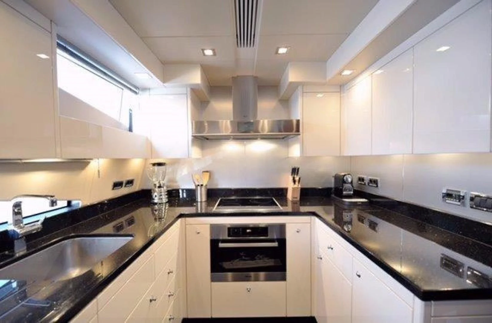 a kitchen with white cabinets aboard SPLASHED OUT Yacht for Sale
