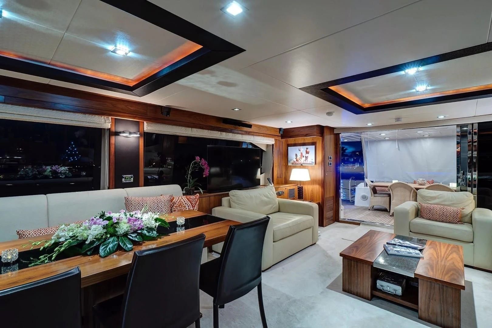 a living room with a large screen aboard SPLASHED OUT Yacht for Sale