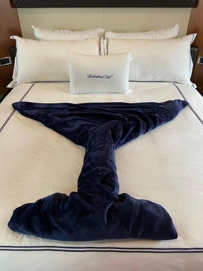 a bed with blue sheets aboard SPLASHED OUT Yacht for Sale
