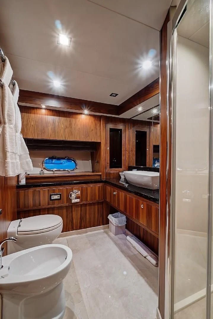 a bathroom with wooden cabinets aboard SPLASHED OUT Yacht for Sale