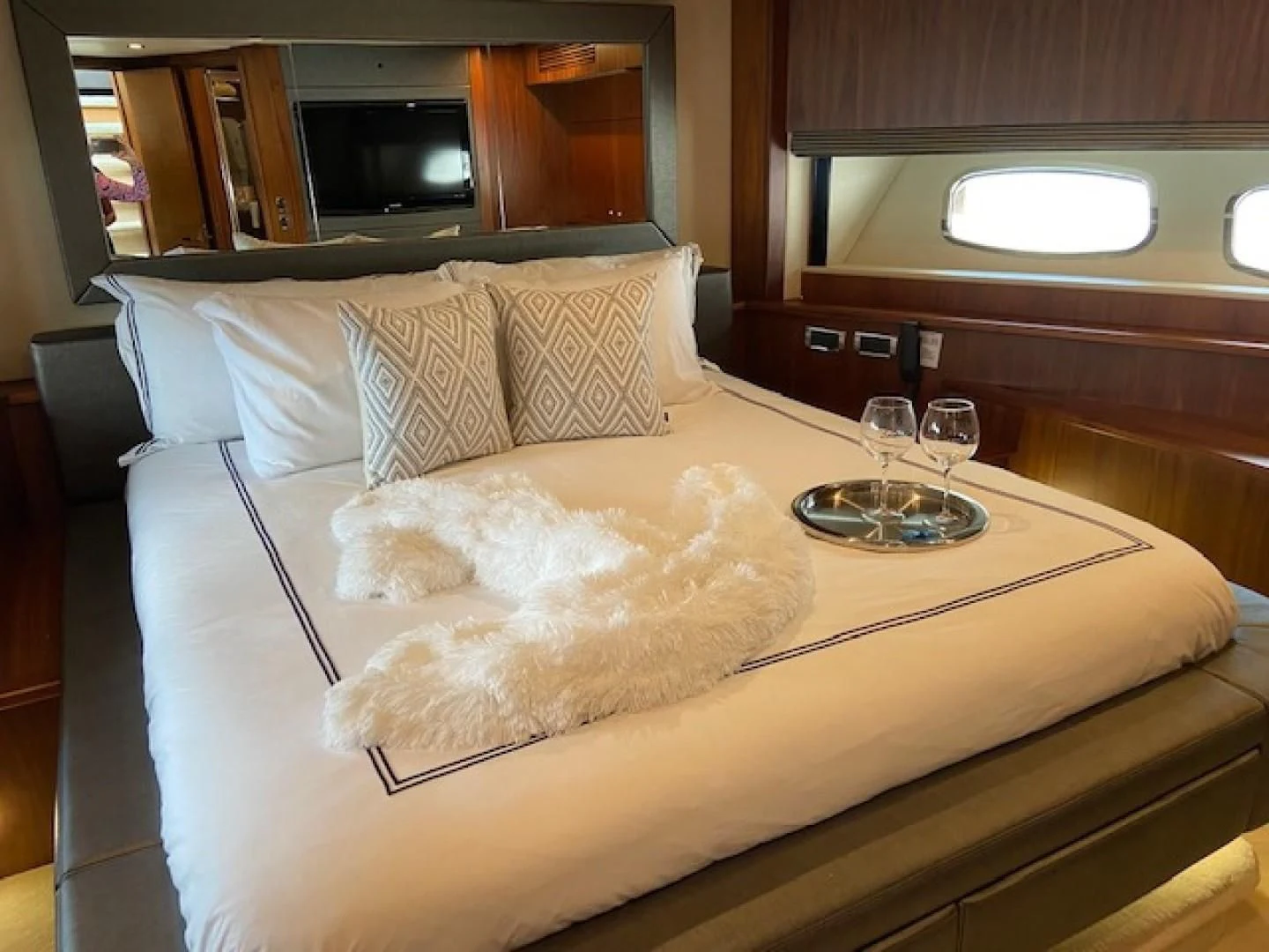 a bed with a white pillow and glasses on it aboard SPLASHED OUT Yacht for Sale