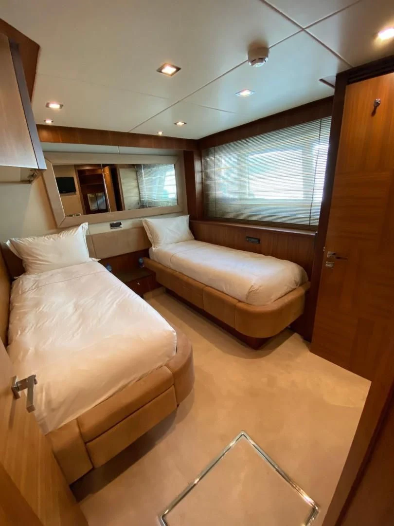 a room with a bed and a desk aboard SPLASHED OUT Yacht for Sale