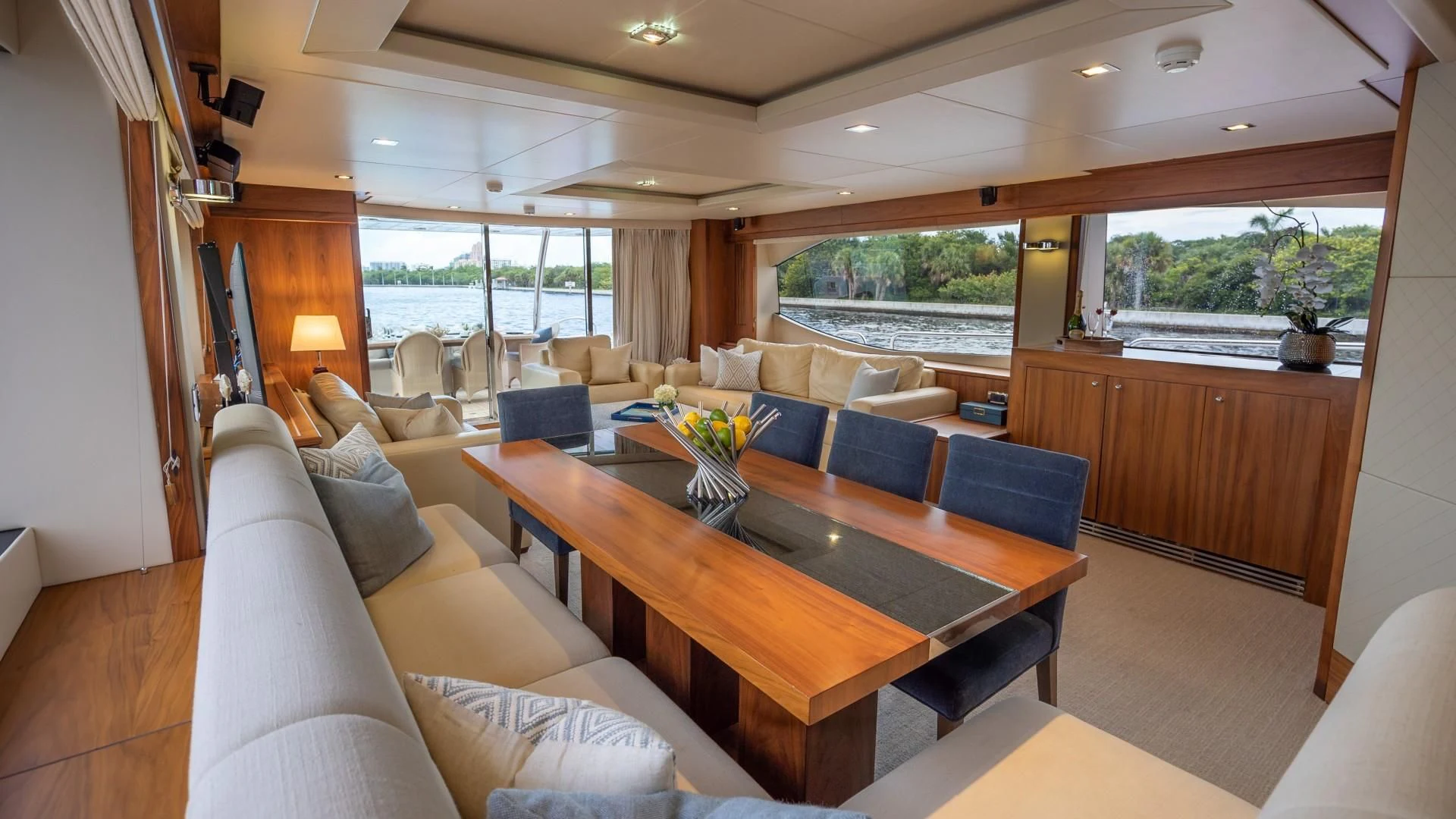 a living room with a table and couches aboard SPLASHED OUT Yacht for Sale
