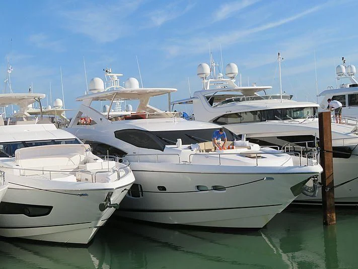 several boats docked at a pier aboard SPLASHED OUT Yacht for Sale