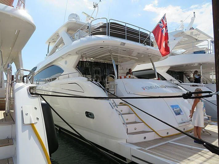 a boat with a flag on the front aboard SPLASHED OUT Yacht for Sale