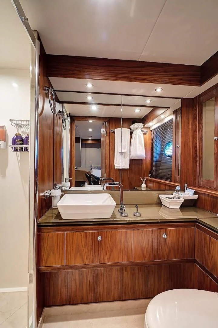 a bathroom with a large mirror aboard SPLASHED OUT Yacht for Sale