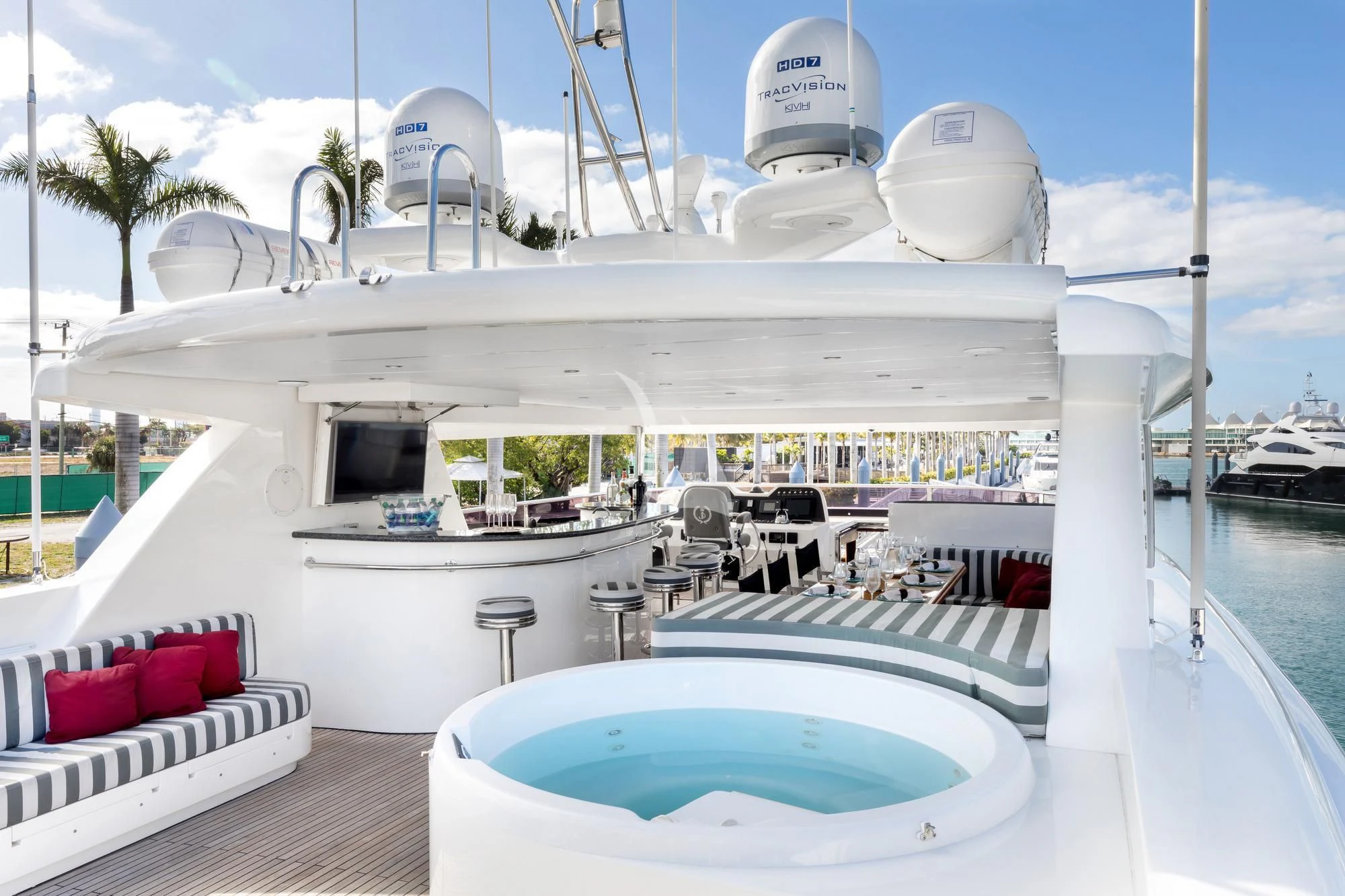 a white building with a pool and lounge chairs on a deck aboard JULIA DOROTHY Yacht for Sale