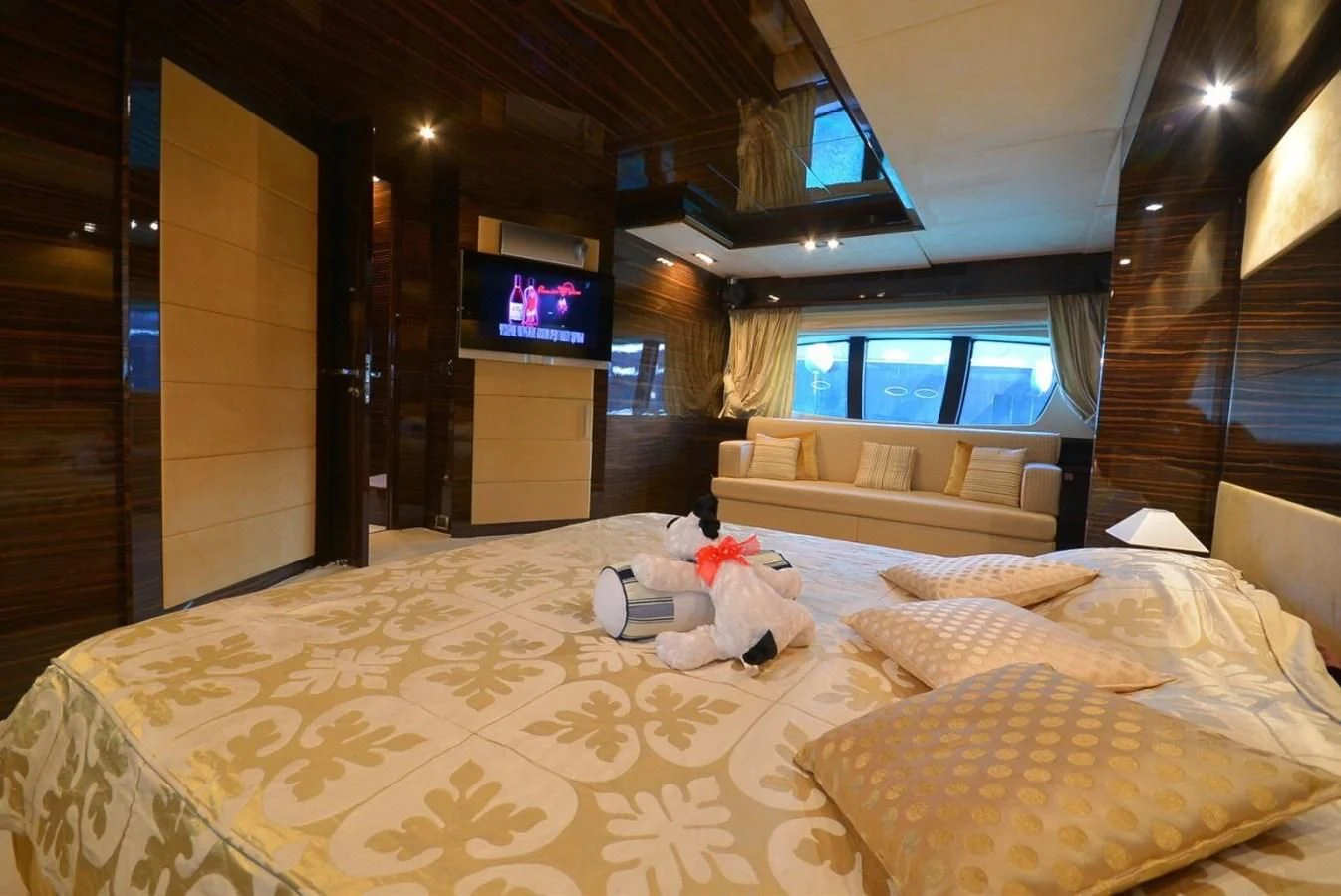 a bed with a television on the wall aboard JULIA DOROTHY Yacht for Sale