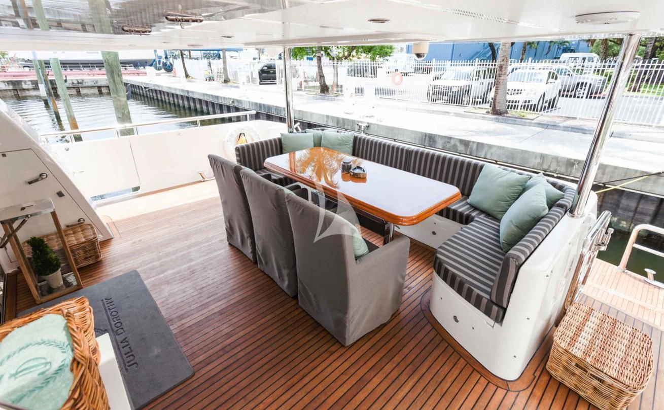 a room with a table and chairs aboard JULIA DOROTHY Yacht for Sale