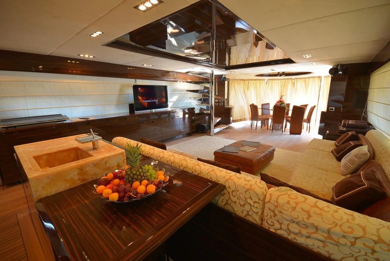 a room with a table and couches aboard JULIA DOROTHY Yacht for Sale